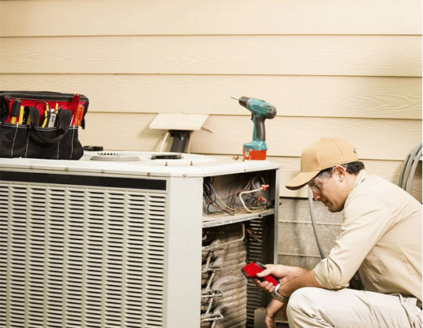 a technician is check the heat pump outdoor unit
